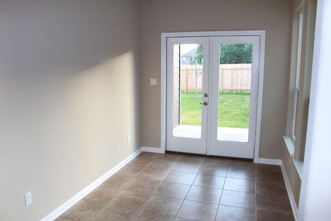 Entryway with french doors, healthy amount of natural light, baseboards, and light tile patterned floors | Image 18
