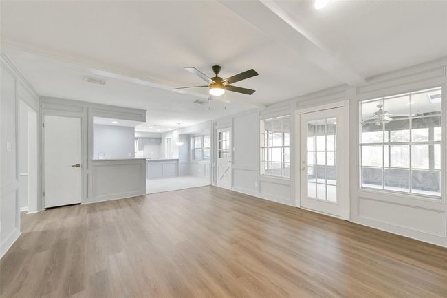 New floors. Photo from fireplace looking to wet bar & breakfast room. To the right is the sun-room. | Image 5