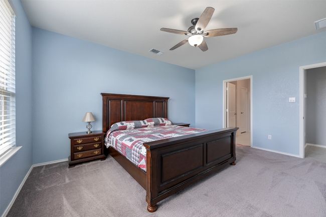 Bedroom with baseboards, visible vents, and light colored carpet | Image 17