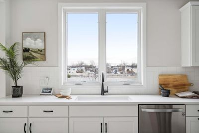 Inspiration photo of similar previously built model home. Options, upgrades and features may vary. Beautiful kitchen window invites natural light, offering a view while doing dishes. | Image 1