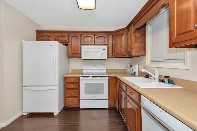 Kitchen - wood flooring and cabinets, white appliances | Image 5