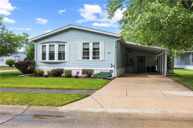 Manufactured / mobile home featuring a carport, concrete driveway, and a front lawn | Image 8