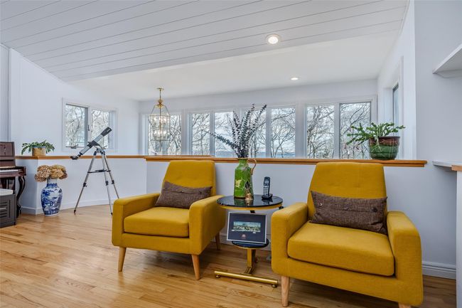Living area featuring recessed lighting, light wood-type flooring, baseboards, and a notable chandelier | Image 5
