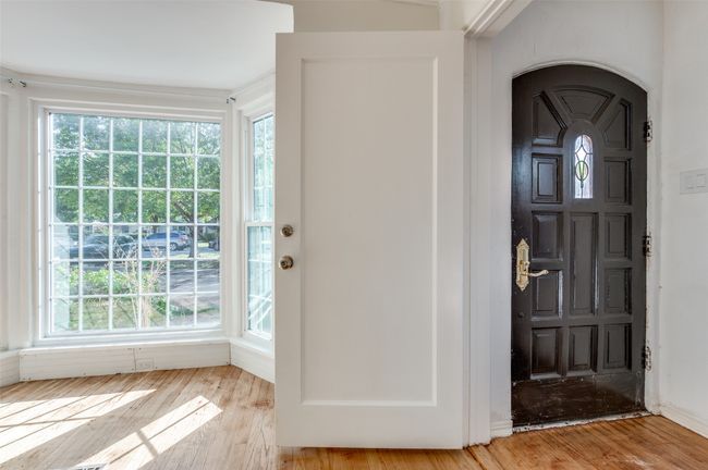 Foyer entrance featuring plenty of natural light, wood finished floors, and arched walkways | Image 4