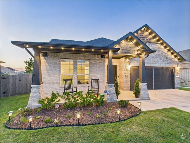 View of front facade with concrete driveway, a garage, and brick siding | Image 4