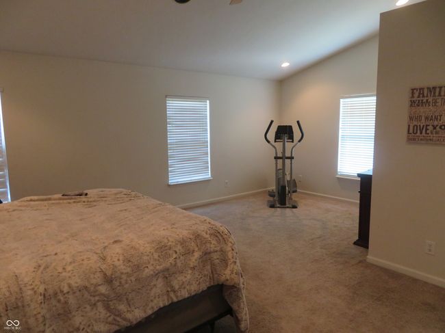 Primary Bedroom with sitting area or use it for an exercise area. Vaulted ceiling with display shelves at ceiling. | Image 30