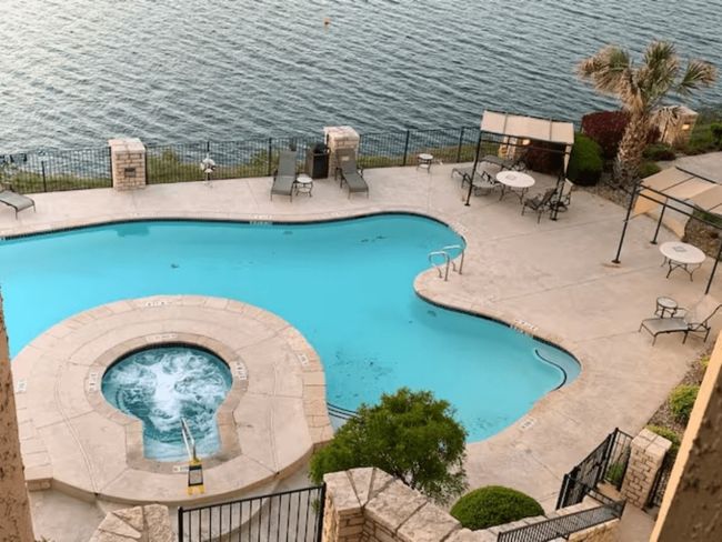 Community pool with a hot tub and a patio | Image 36