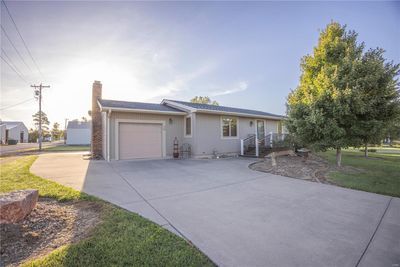 Ranch-style home with a garage and a front lawn | Image 1