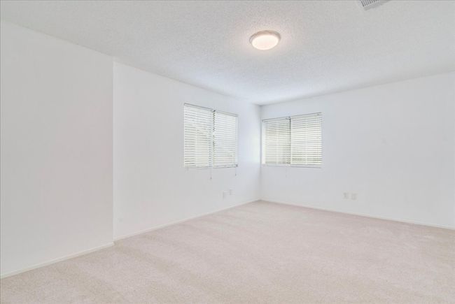 Spare room featuring light carpet, a textured ceiling, and baseboards | Image 28