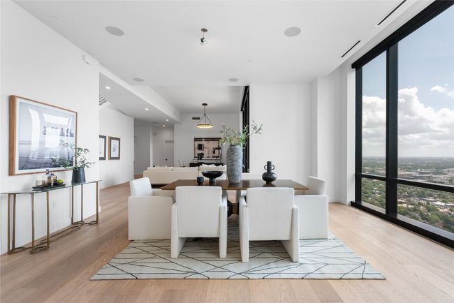 Dining room featuring light wood-style floors and a wall of windows | Image 37
