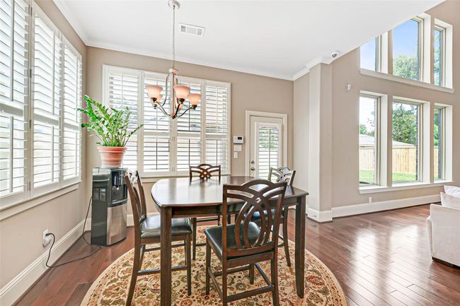 A bright and airy space that overlooks the backyard—ideal for casual meals or morning coffee. | Image 18