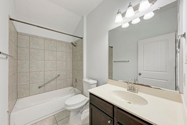 Bathroom with tile patterned flooring, toilet, shower / bathtub combination, and vanity | Image 28