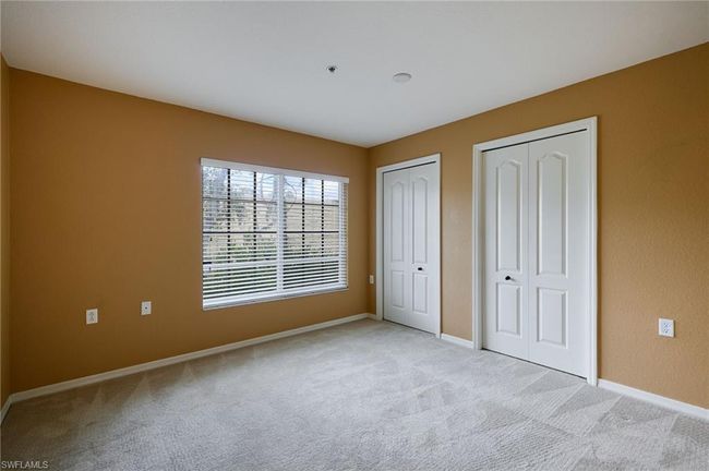 Unfurnished bedroom featuring multiple closets and light carpet | Image 10