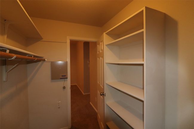 Walk in closet with dark carpet | Image 25