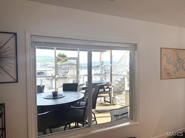 Dining area with healthy amount of natural light, a water view, and baseboards | Image 19
