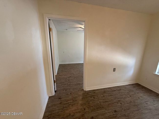 living room looking to the 2nd bedroom, with access to the screened in porch and private en-suite | Image 53