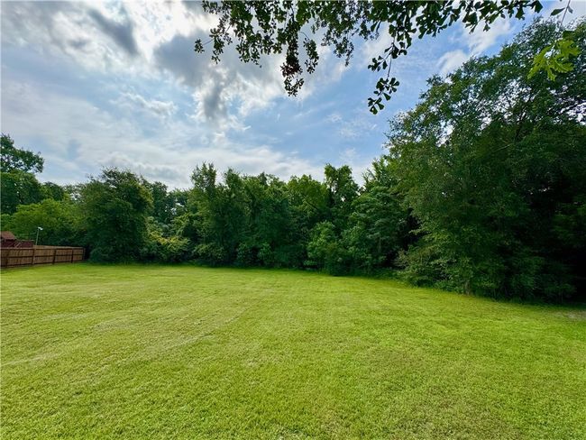 View of yard featuring a forest view | Image 6