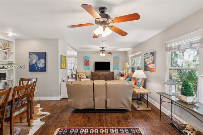 Primary living room with hardwood floors, ample seating, bright natural lighting, smooth ceilings. | Image 32