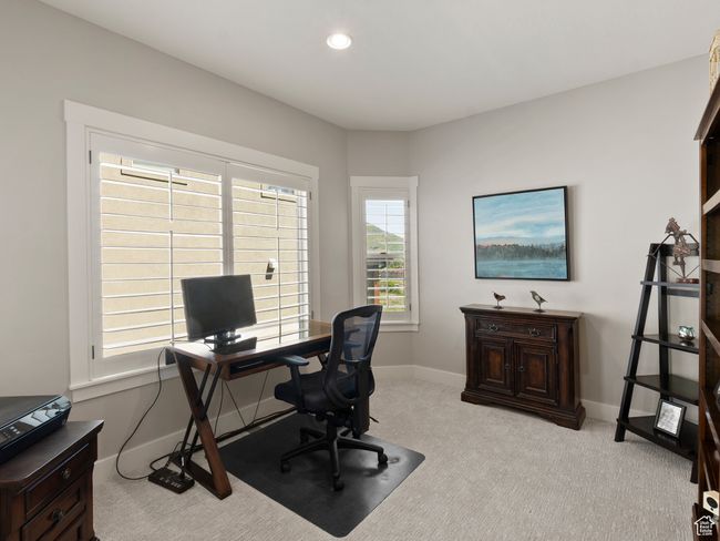 Office space just off entryway with light colored brand new carpet, baseboards, and recessed lighting with view to the north | Image 11