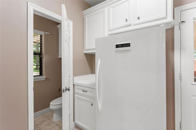 Another side of the utility room with stand up freezer and half bath. Door to the right opens to the carport. | Image 26