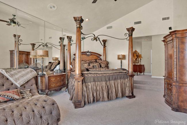 Carpeted bedroom with visible vents and high vaulted ceiling | Image 26