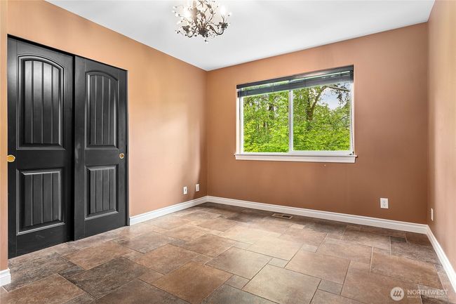 Second upper guest bedroom also looks out to the greenspace behind the house. | Image 23
