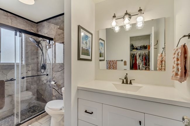 Full bath featuring a shower stall, toilet, and vanity | Image 27