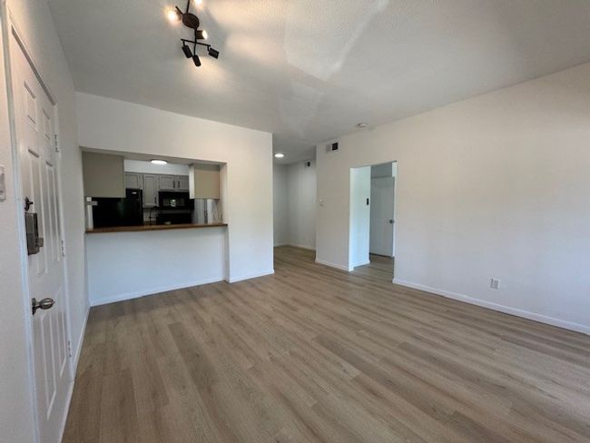 Unfurnished living room featuring wood finished floors and baseboards | Image 14