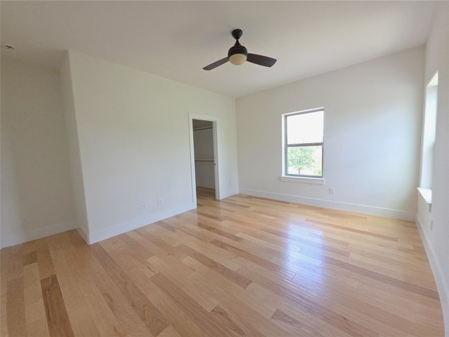 Spare room with light wood-style flooring, ceiling fan, and baseboards | Image 23