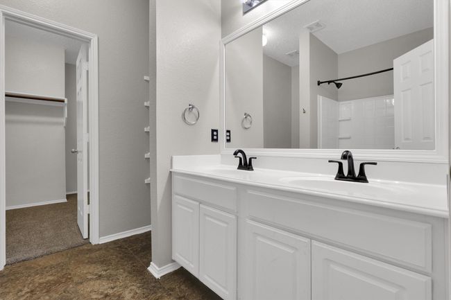 Full bath with double vanity, a shower, and a spacious closet | Image 20