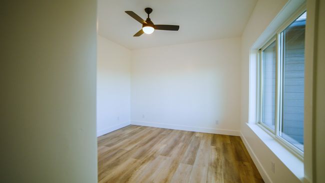Unfurnished room with light wood-style floors and a ceiling fan | Image 35