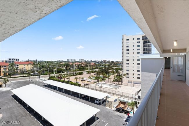 Stepping outside your door, you have a clear and convenient view of the covered carport just a short walk away. The carport provides easy access for unloading and loading, sheltered from sun and rain, making coming and going effortless. | Image 8