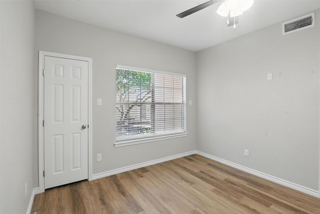 Unfurnished room with baseboards, a ceiling fan, wood finished floors, and visible vents | Image 13