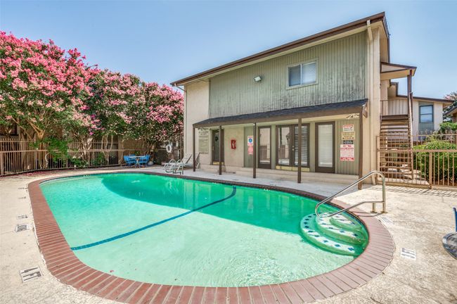 Community pool with a patio area and stairway | Image 25