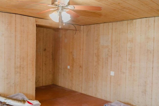 room featuring wood walls, wooden ceiling, and ceiling fan | Image 24