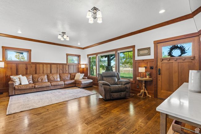 Living room featuring ornamental molding, dark hardwood / wood-style flooring, and a chandelier | Image 10