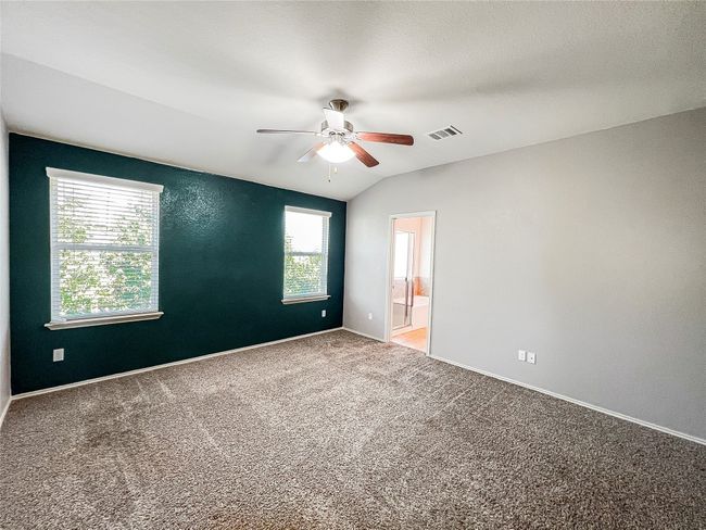 Empty room with ceiling fan, light colored carpet, and lofted ceiling | Image 19