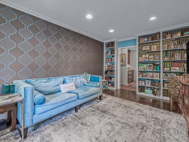 Living area with wallpapered walls, ornamental molding, wood finished floors, and recessed lighting | Image 4