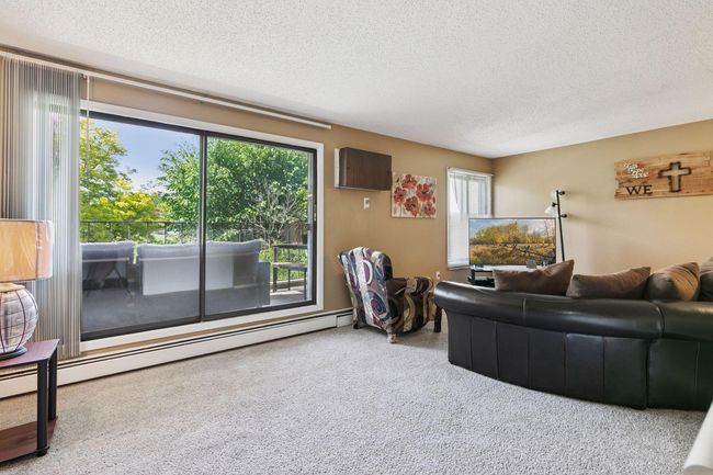 Large patio door brings in a ton of light and makes deck access easy. | Image 11