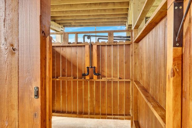 An exterior shower is another feature on the ground level. It can serve as a storage area for water toys. | Image 21