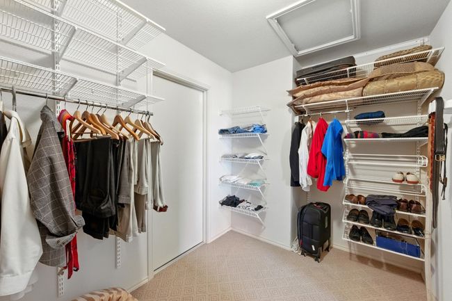 Spacious closet with attic access and carpet | Image 22