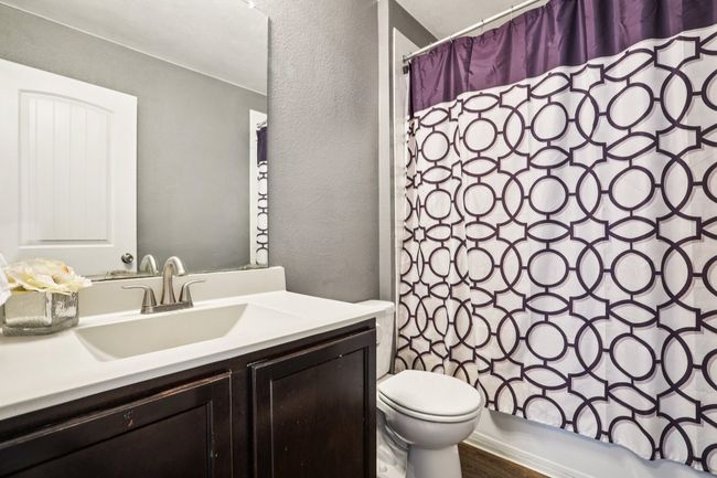 Bathroom featuring vanity, a textured wall, and wood finished floors | Image 28