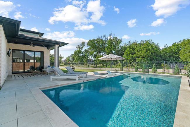 View of swimming pool with a patio and ceiling fan | Image 35