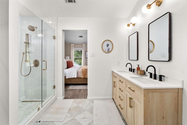 Newly renovated primary bedroom with dual vanity sink, quartz counter tops, walk in shower and linen closet storage. | Image 14