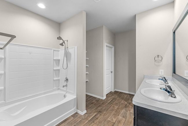 You enter a great primary bathroom suite which offers a tub and shower combo, linen shelving and a toilet room with locking door that the owners installed for privacy. Toilet has bidet! | Image 29