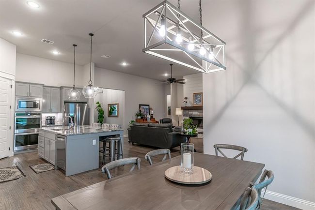 Living room featuring sink, ceiling fan, and dark hardwood / wood-style flooring | Image 15