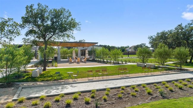 View of home's community with a game area and a lawn | Image 36