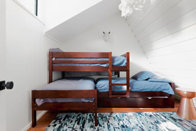 Bedroom featuring lofted ceiling and wood finished floors | Image 12