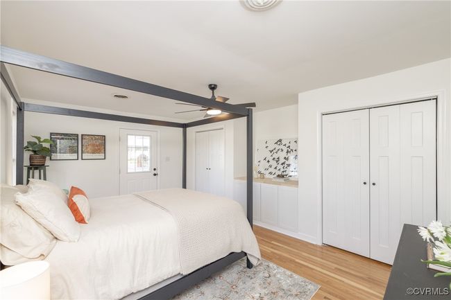 Bedroom with ceiling fan, light wood-style flooring, and two closets | Image 18