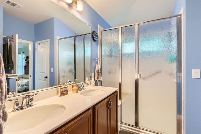Bathroom featuring double vanity, a sink, visible vents, and ensuite bathroom | Image 15